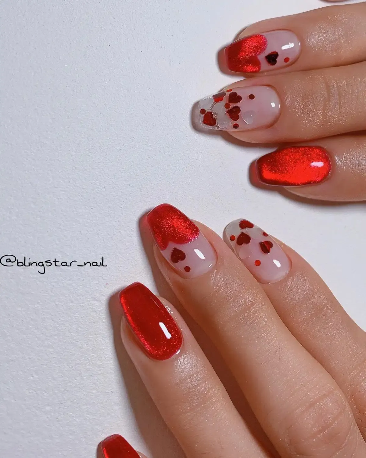 Red velvet nails with hearts for Valentine's Day.