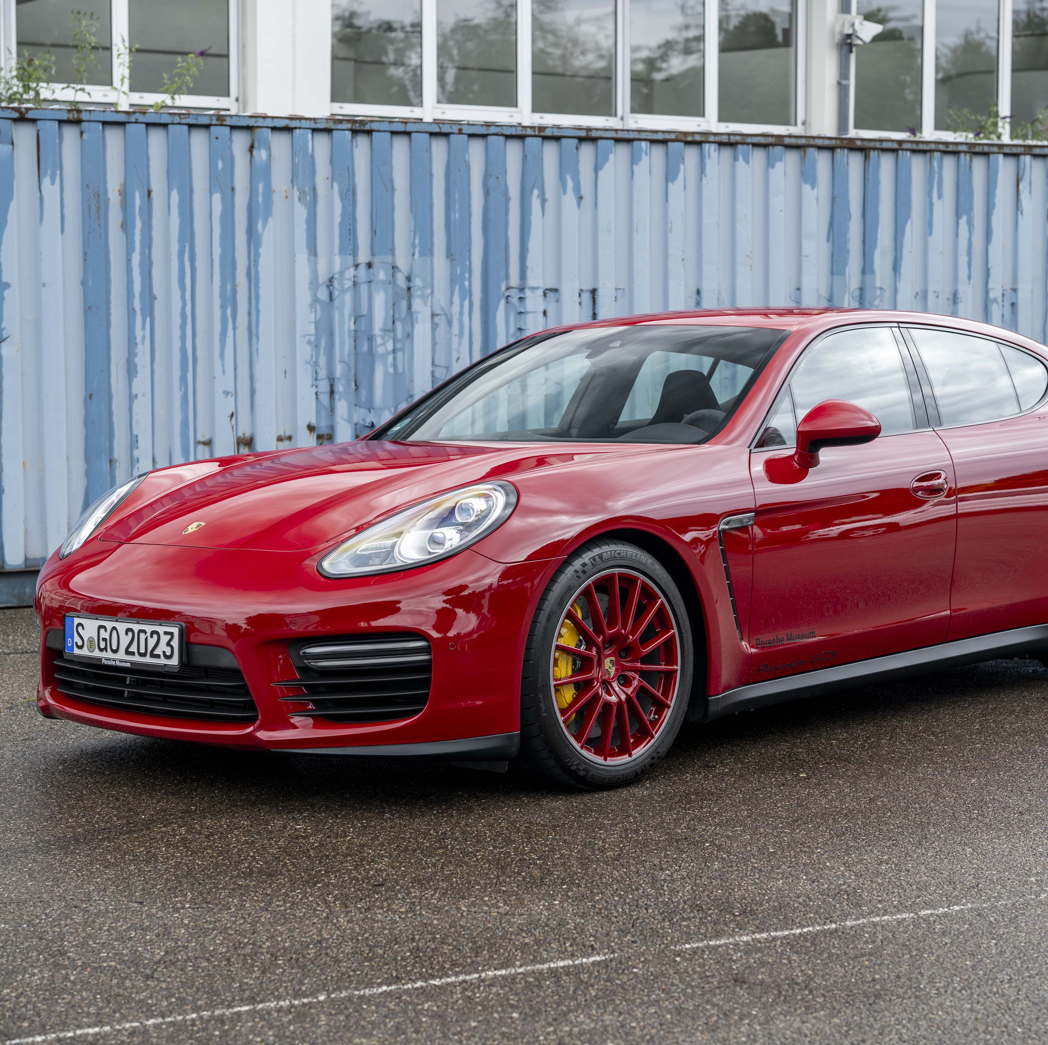 a red car parked in front of a building