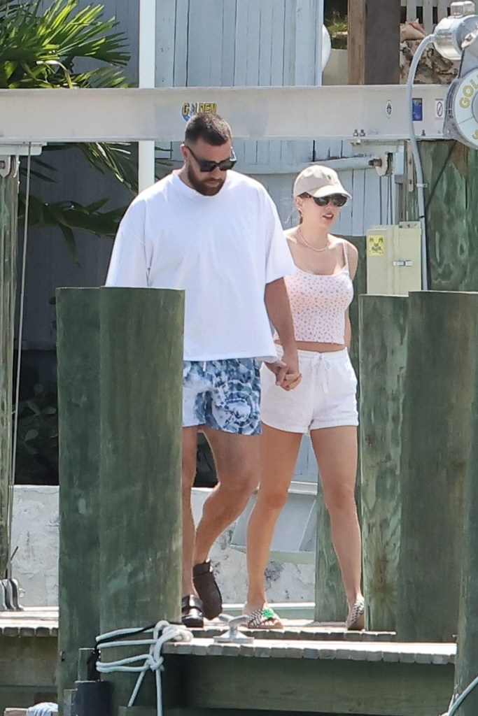 Travis Kelce and Taylor Swift hold hands in the Bahamas on vacation.