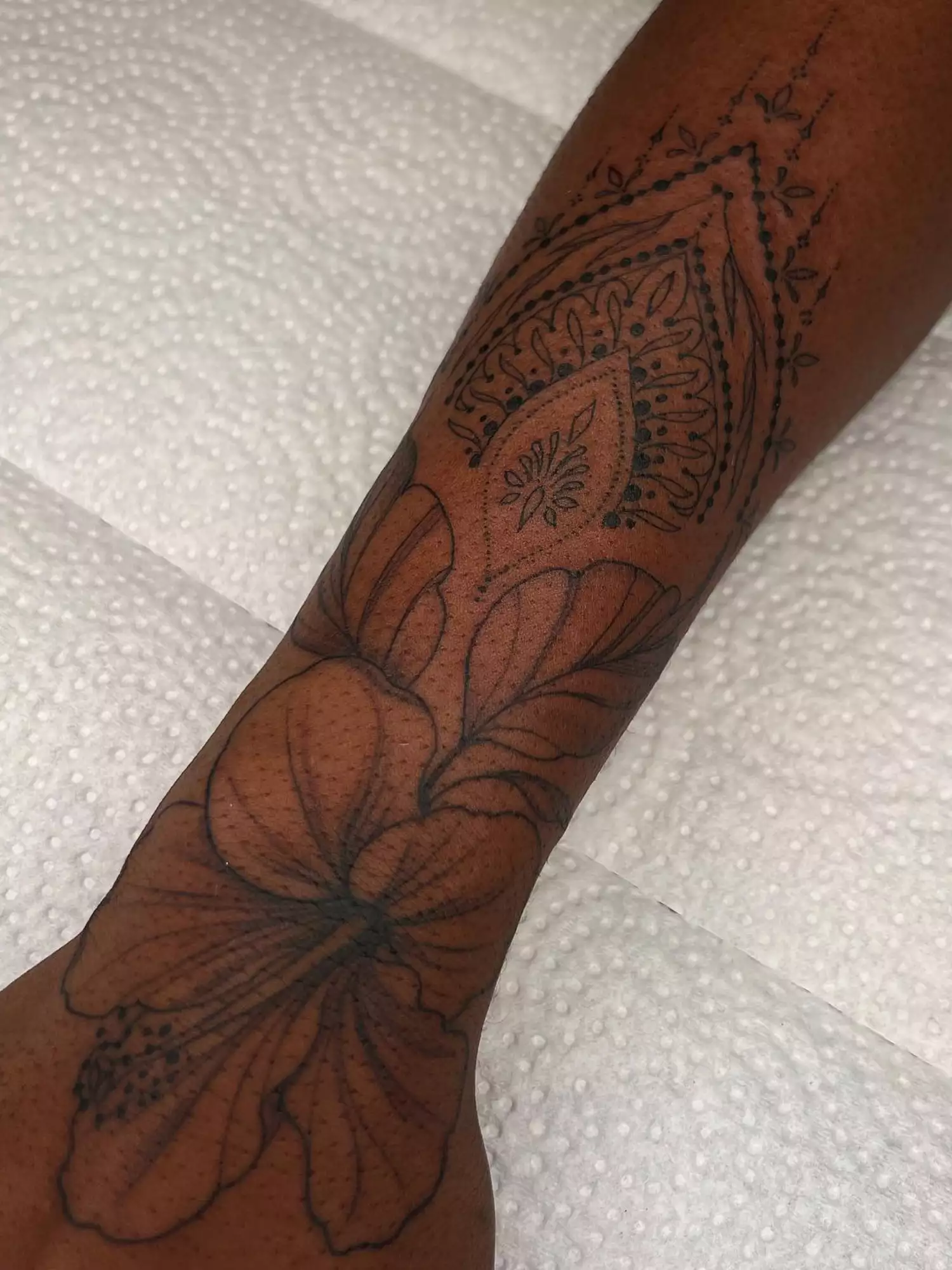 forearm with flower tattoo