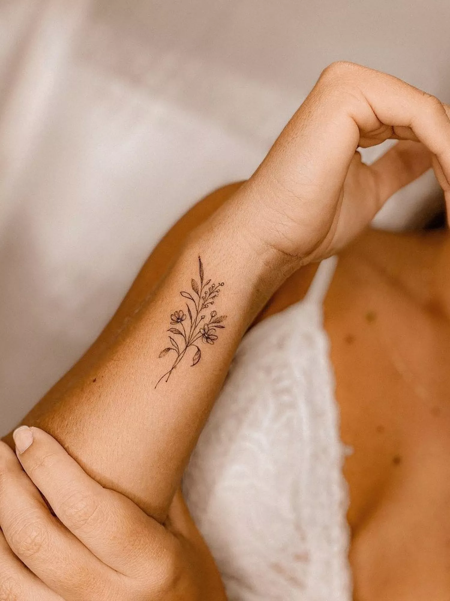 forearm with flower tattoo