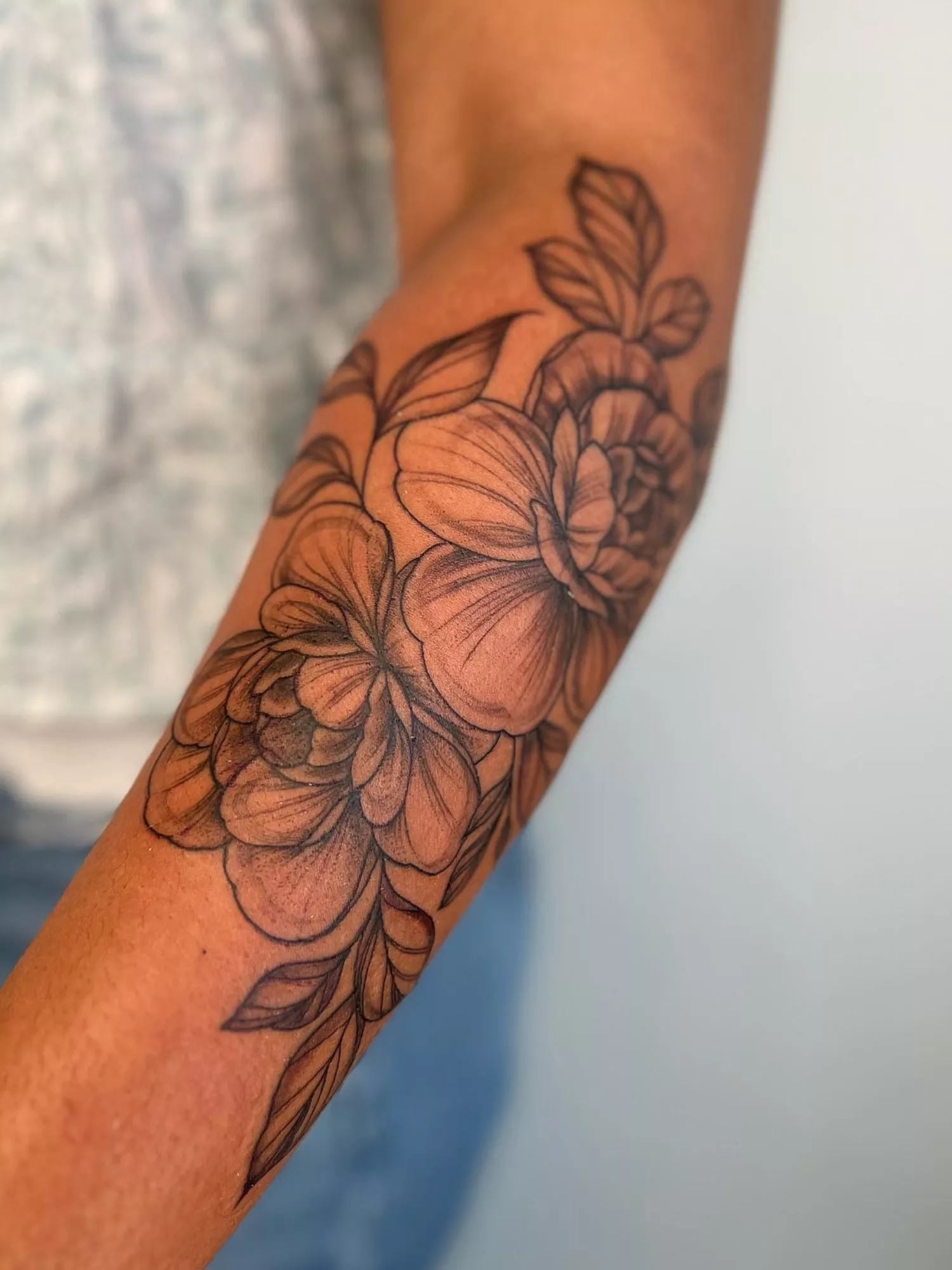 forearm with flower tattoo