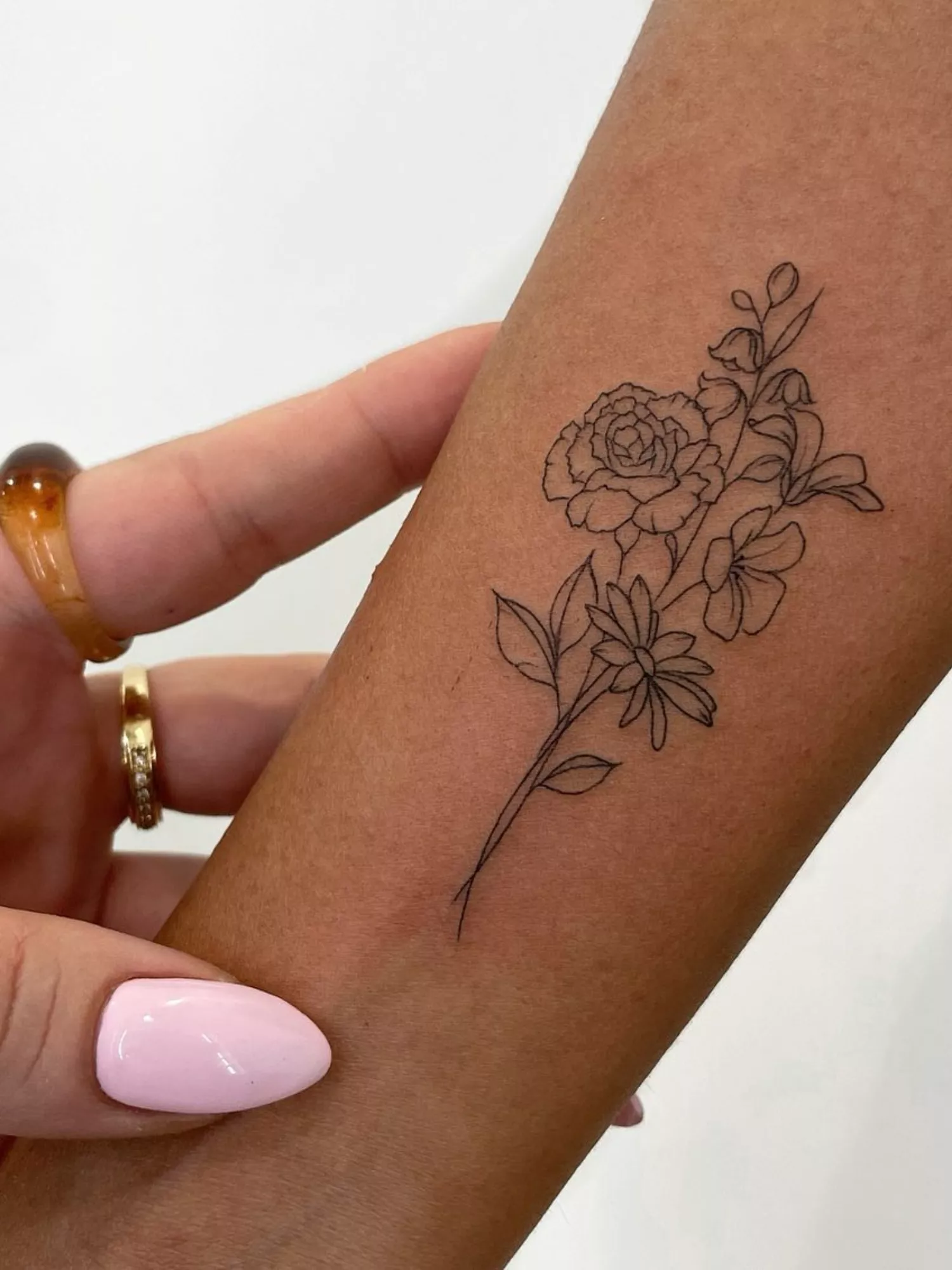 forearm with flower tattoo