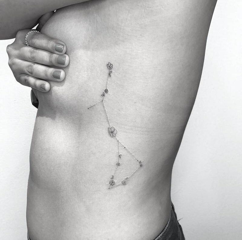 Cancer and Capricorn constellation tattoo on the left side ribcage