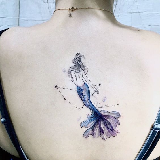 Lady sea goat and Capricorn constellation tattoo on the back