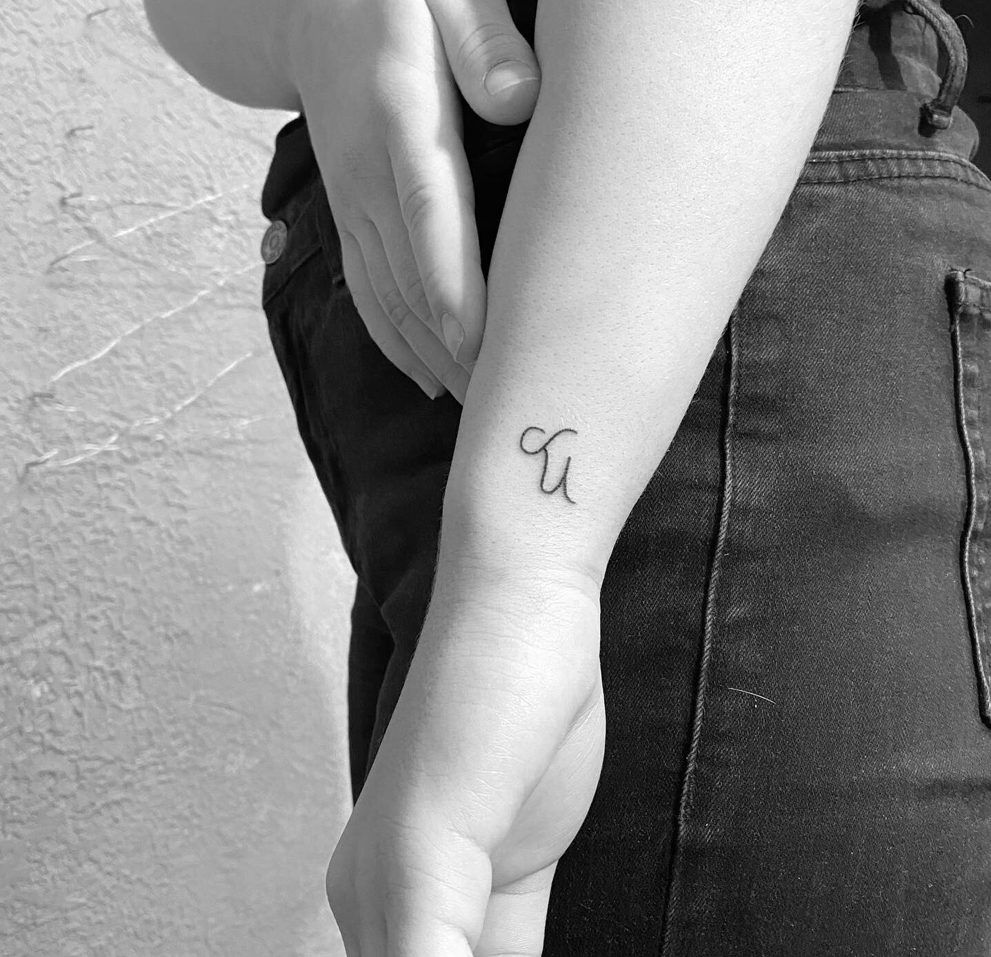 Minimalistic style Capricorn zodiac symbol tattoo located on the wrist