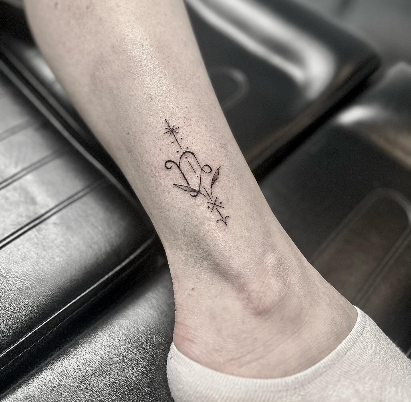 Capricorn zodiac symbol tattoo located on the ankle