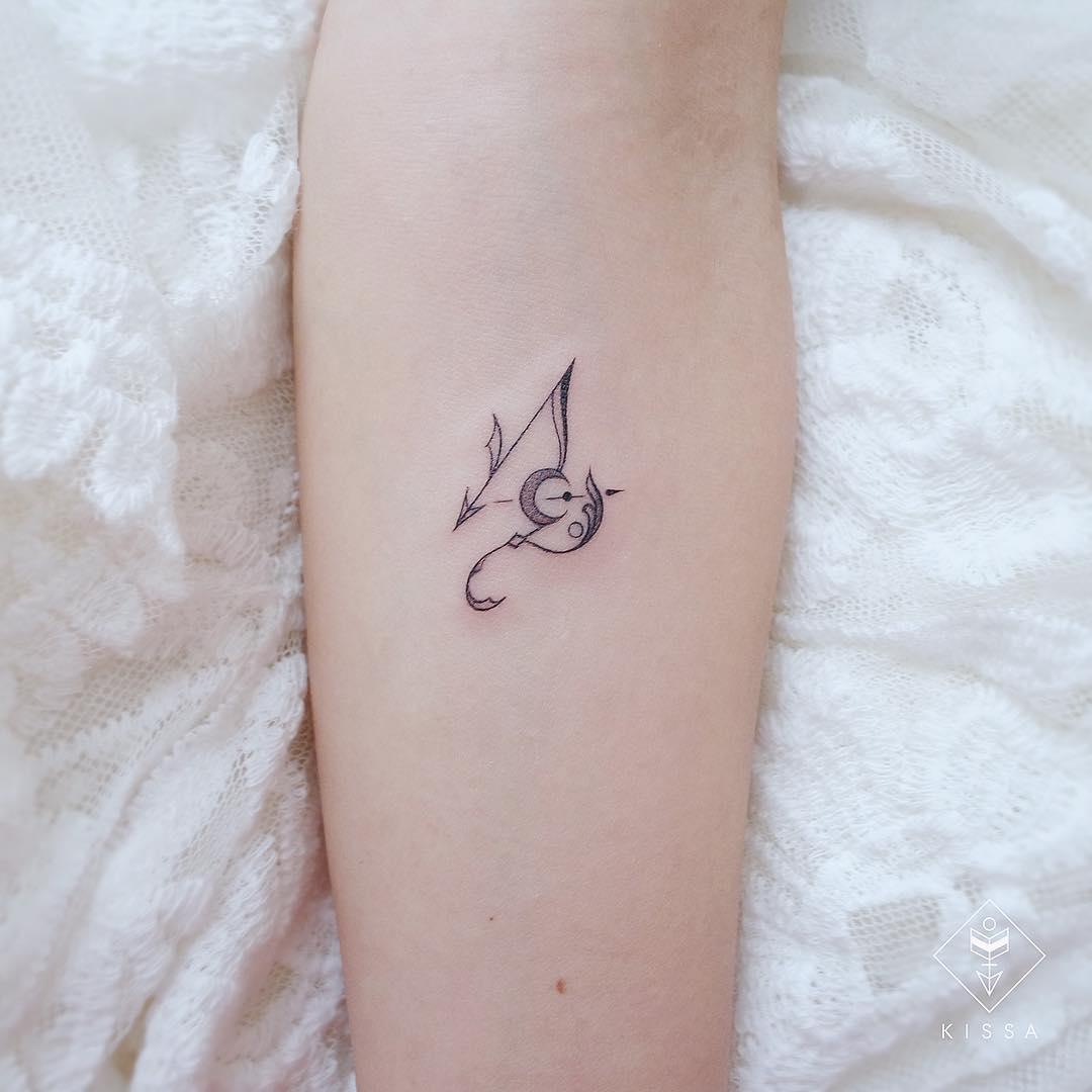 Capricorn symbol and Saturn tattoo located on the inner forearm