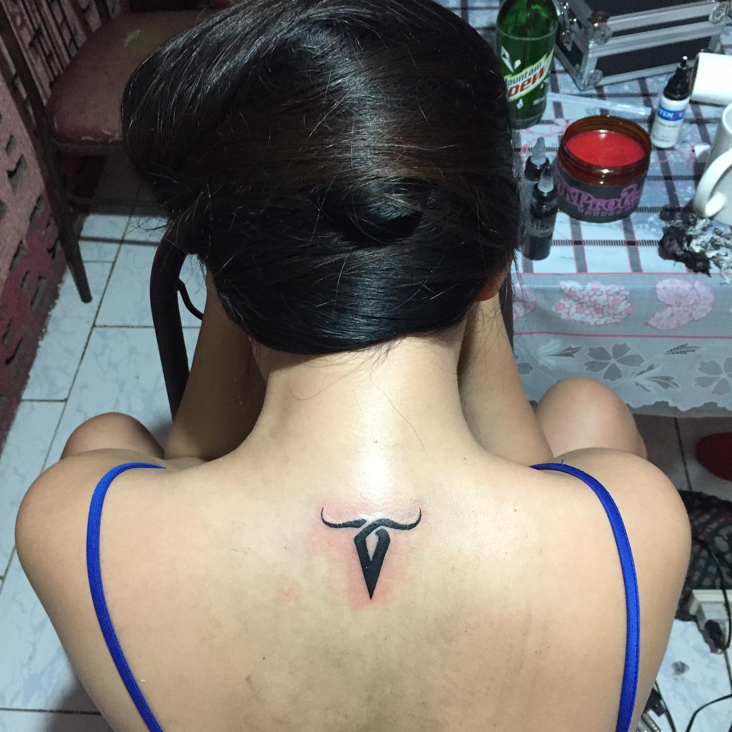 Capricorn symbol tattooed on the upper back