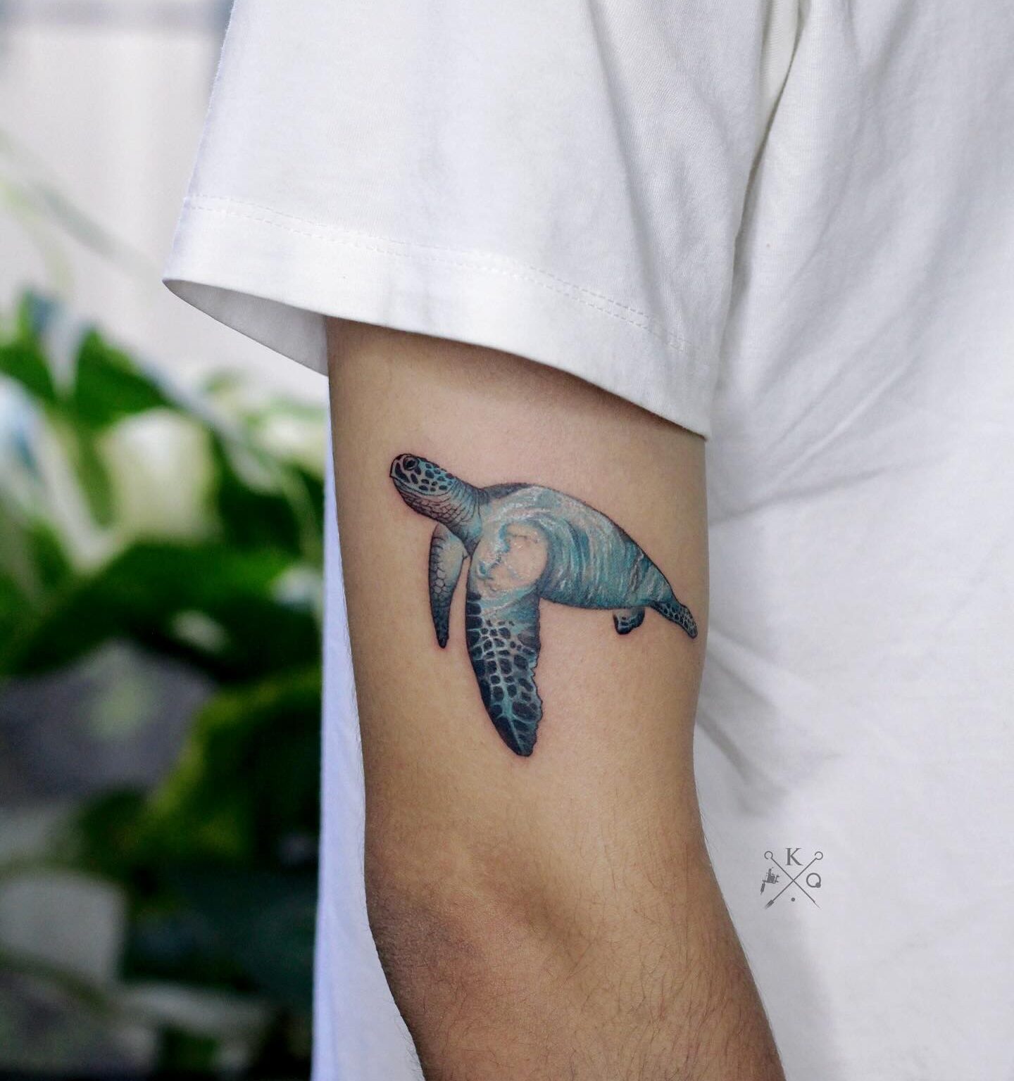 Watercolor style sea turtle tattoo on the right arm