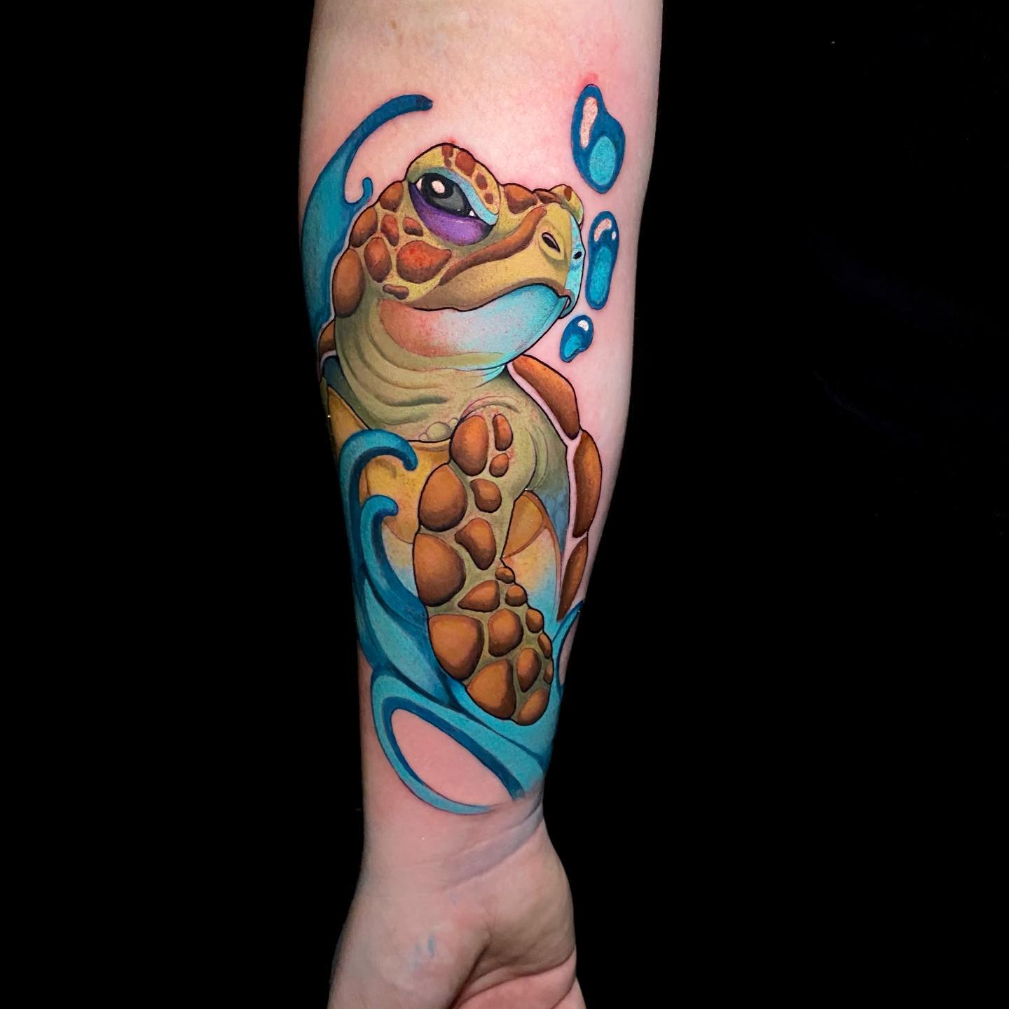 Watercolor style sea turtle tattoo on the left forearm