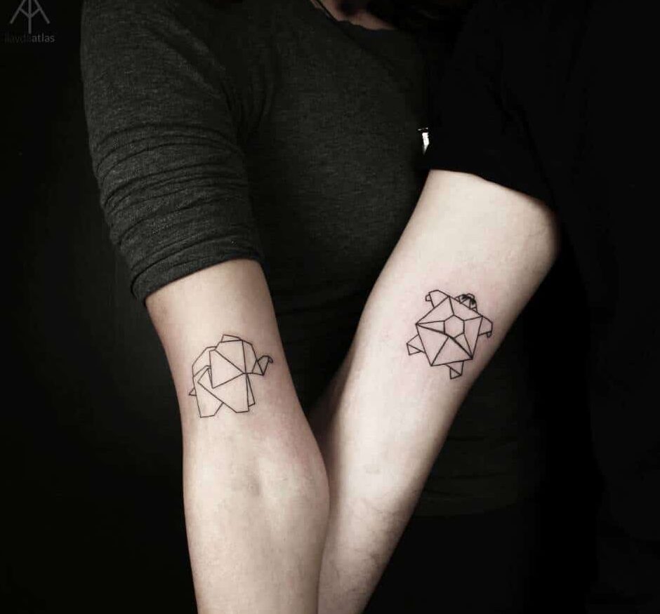 Origami style elephant and turtle couple tattoo on their arm