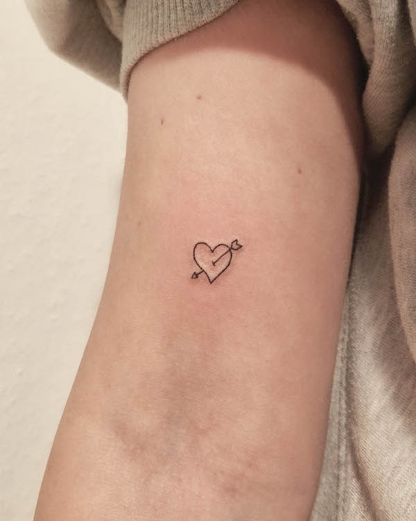 Tiny heart and arrow tattoo by @angiehandpokes