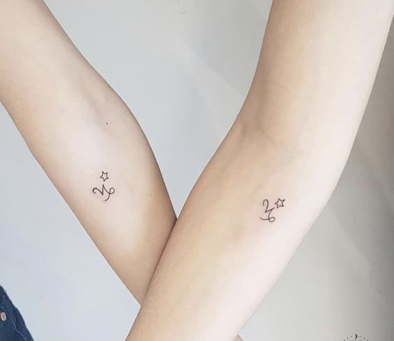Matching Capricorn symbol tattoo on the forearm for best friends