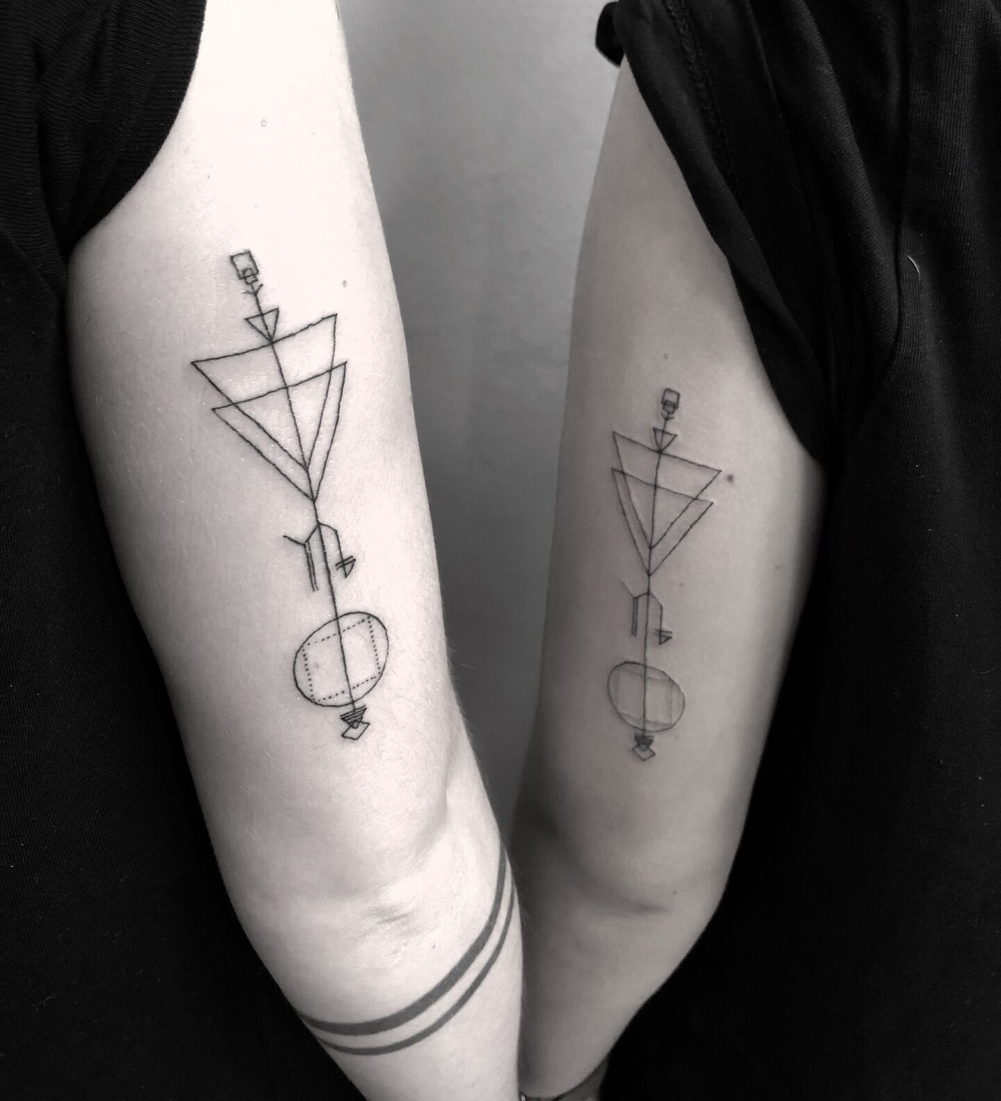 Matching geometric Capricorn tattoo for couples