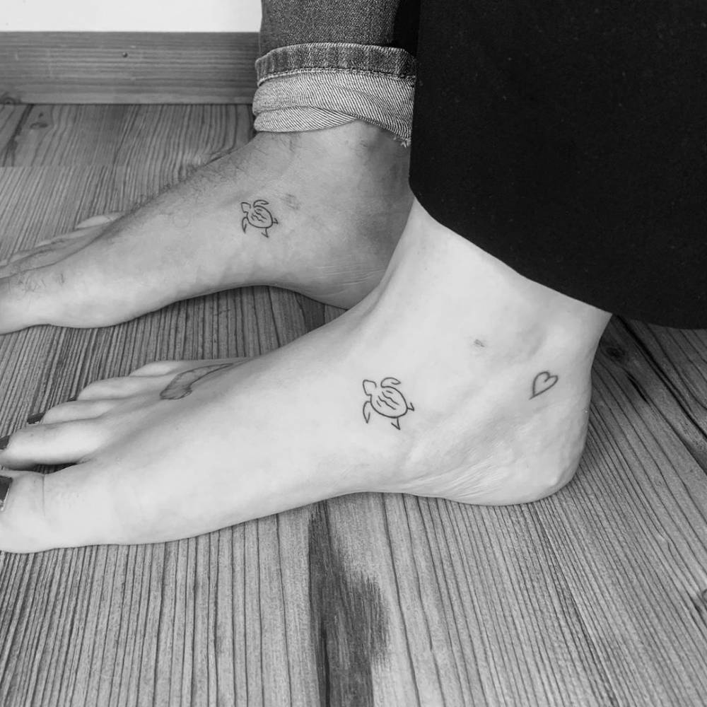 Minimalist matching turtle tattoo on the foot
