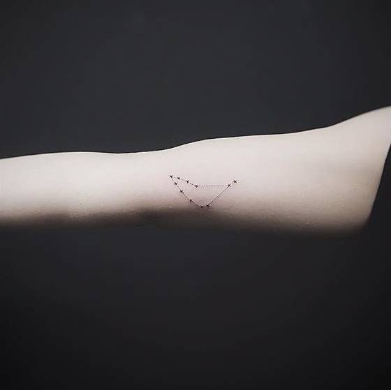 Minimalist Capricorn constellation tattoo on the right inner arm