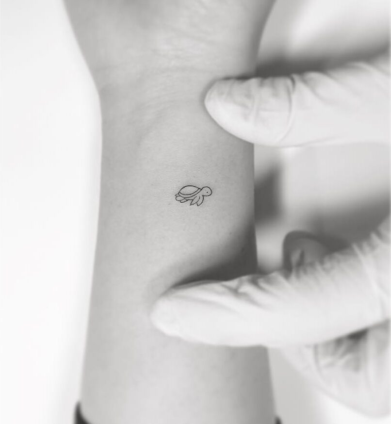 Minimalistic style turtle tattoo on the wrist
