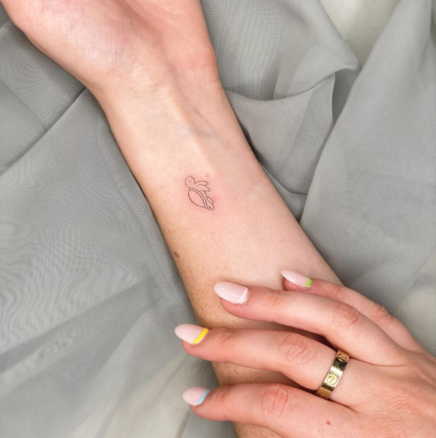 Minimalistic turtle tattoo on the wrist
