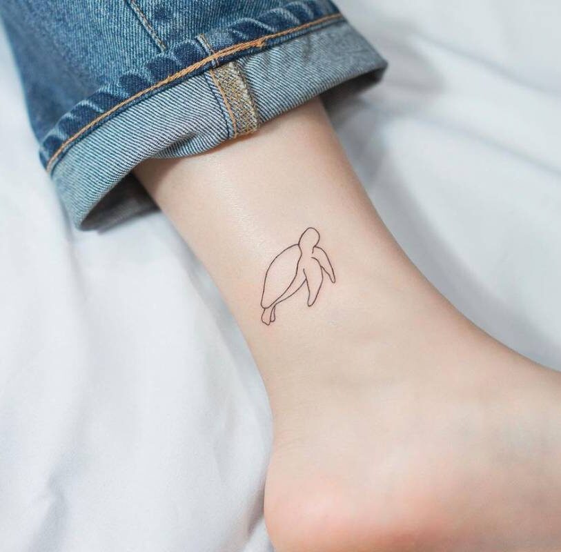 Minimalistic turtle tattoo on the ankle