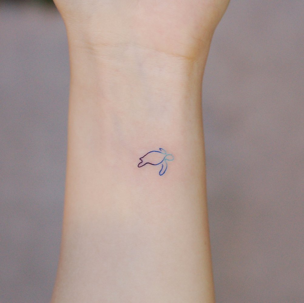Minimalist one line turtle tattoo on the wrist