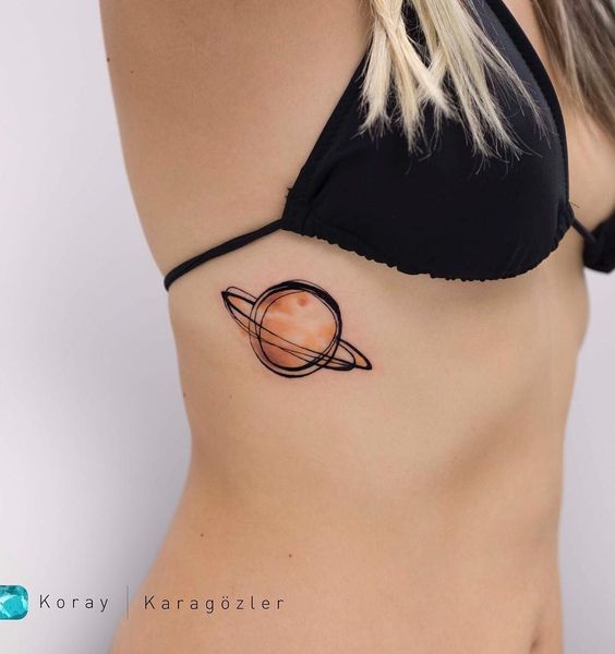 Planet Saturn tattoo located on the rib