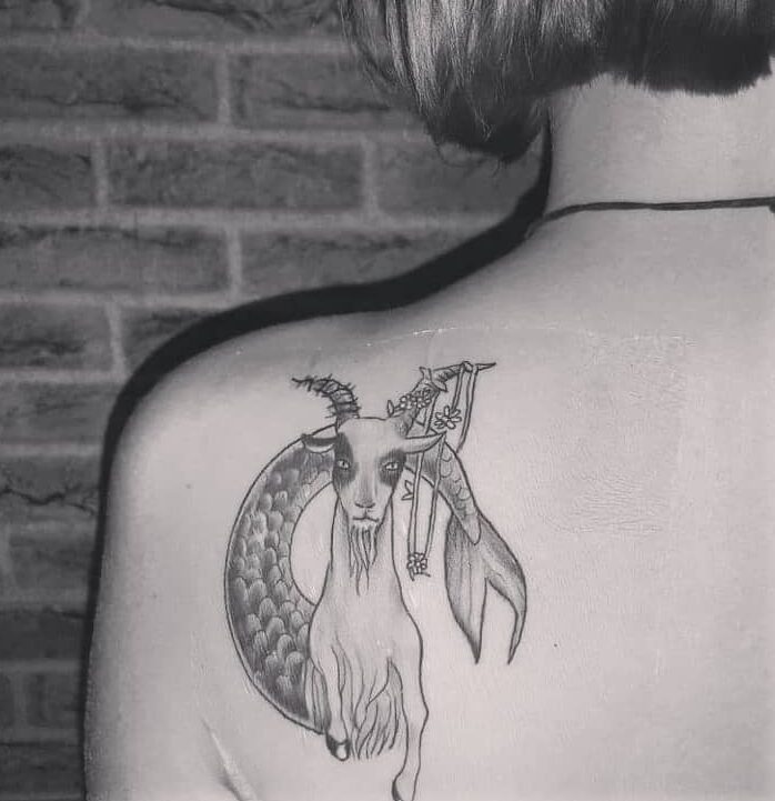 Sea goat tattoo located on the back shoulder