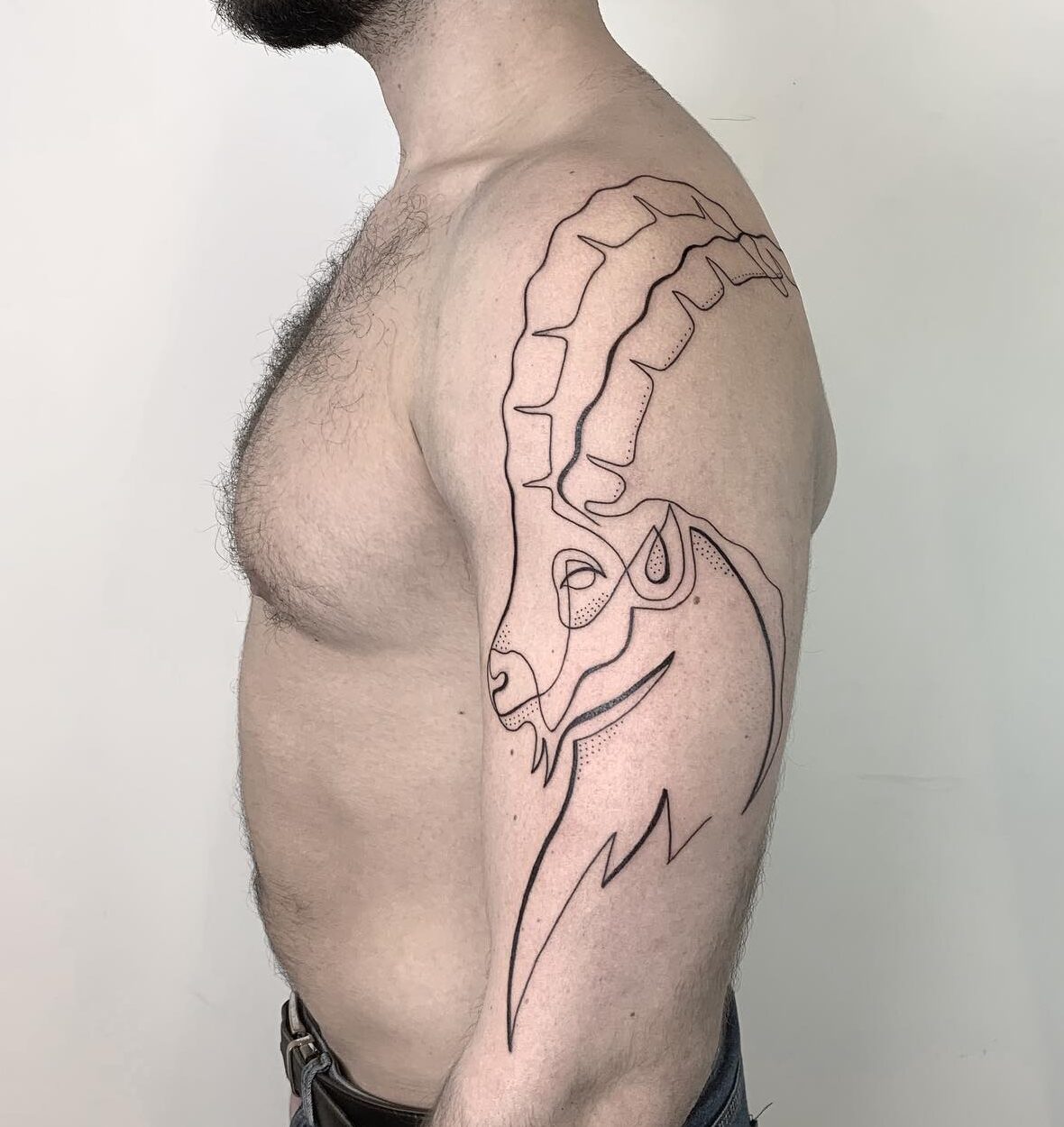 Single line sea goat tattoo on the arm