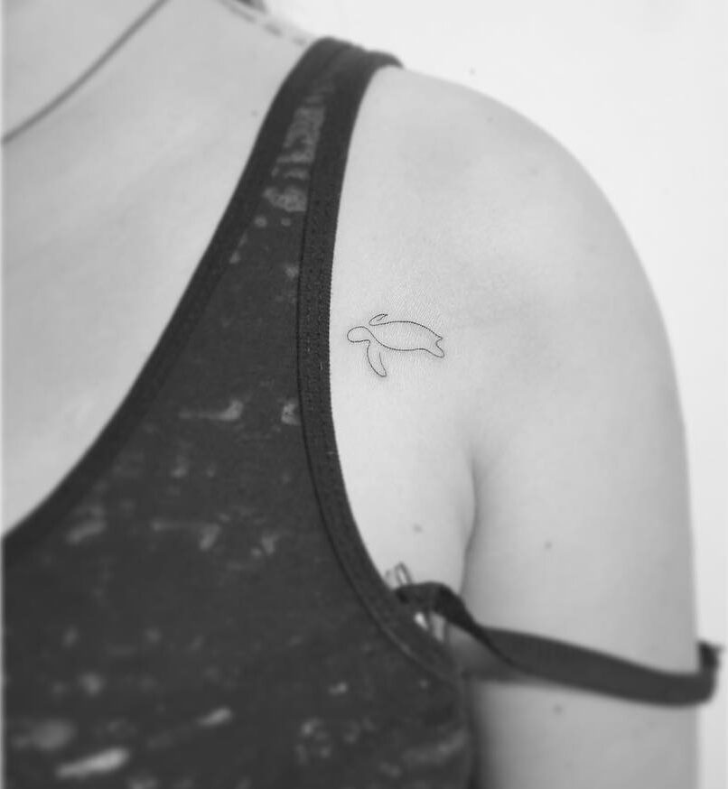 Fine line turtle tattoo on the shoulder