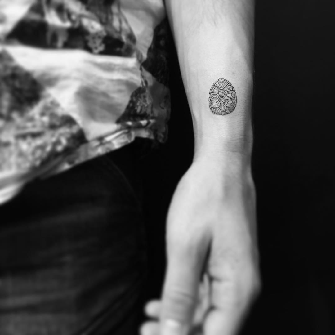 Small turtle shell tattoo on the wrist
