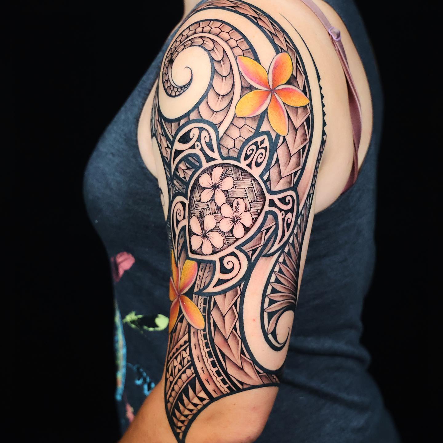 Abstract design tattoo with sea turtle on the left arm