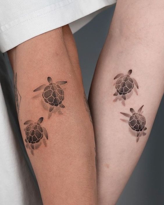 Illustrative sea turtle couple tattoo on the forearm