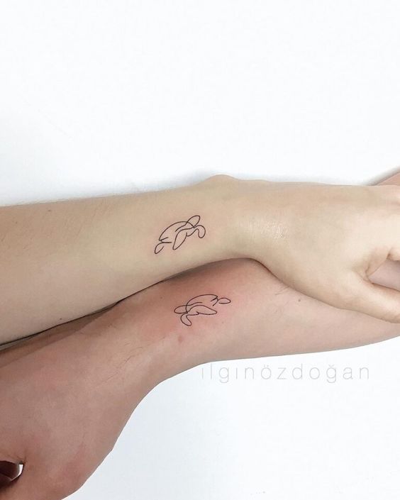 Single line sea turtle couple tattoo on the wrist