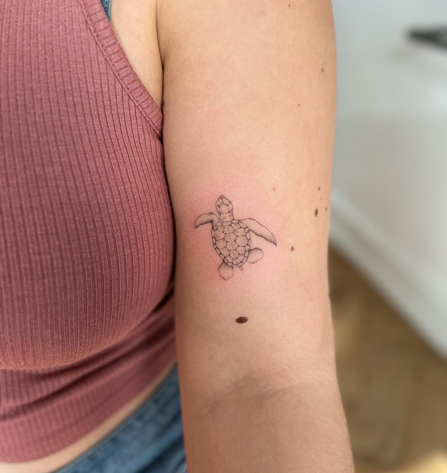 Sea turtle tattoo on the inner arm