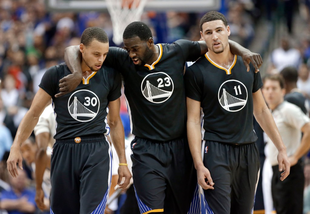 Golden State Warriors guard Stephen Curry (30), Draymond Green (23) and Klay Thompson (11) walk up court during the second half of an NBA basketball game against the Dallas Mavericks, Saturday, Dec. 13, 2014, in Dallas.