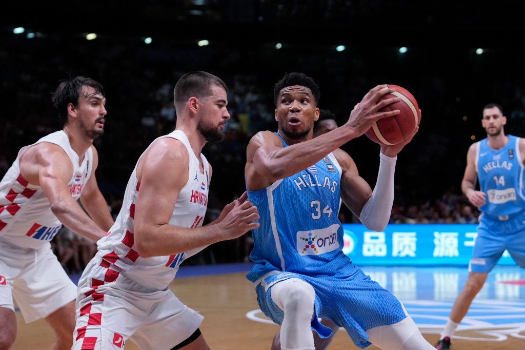 Giannis Antetokounmpo, right, is challenged by Croatia's Ivica Zubac, during a FIBA Olympic Qualifying basketball final.