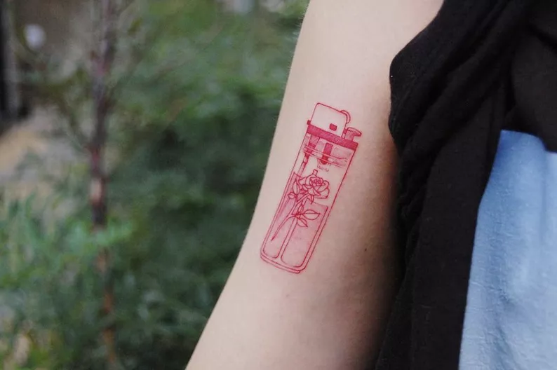 rose lighter tattoo on arm