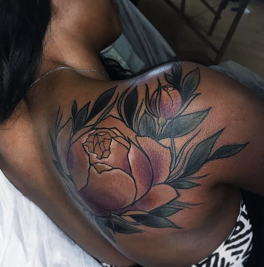 creeping rose tattoo on back and shoulder