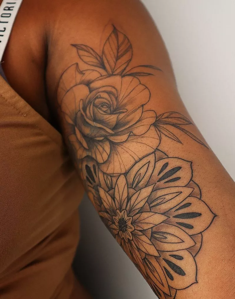 rose tattoo on inside of arm