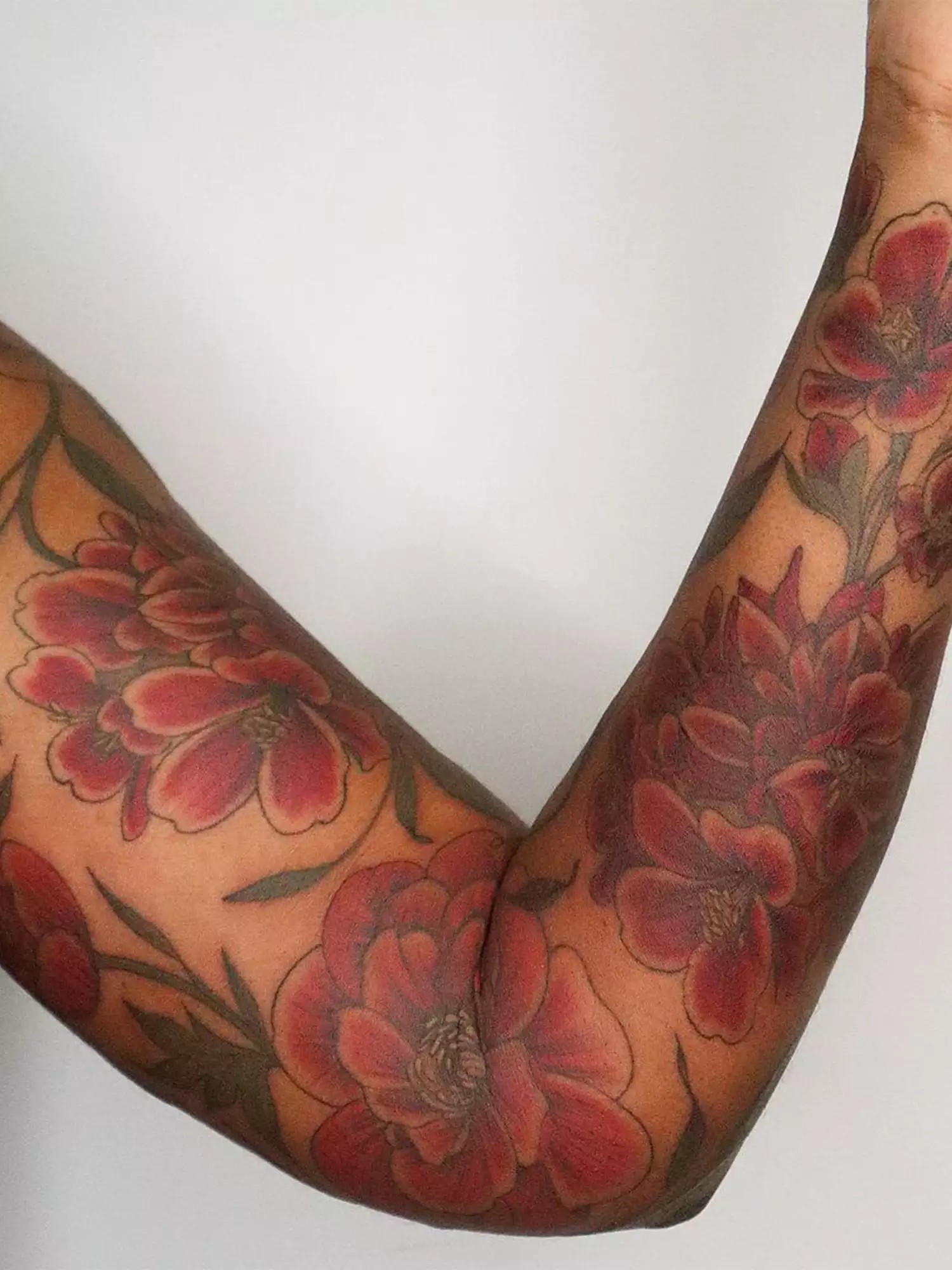 red floral arm tattoo