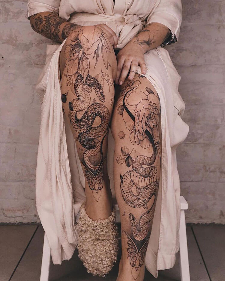 snake and flower tattoo on legs