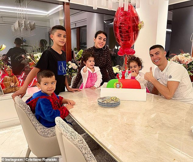 Cute: Recently, Ronaldo took to Instagram to post a snap of his family enjoying a Portugal-themed cake on his 36th birthday, as he also marked his 20th year as a professional football star