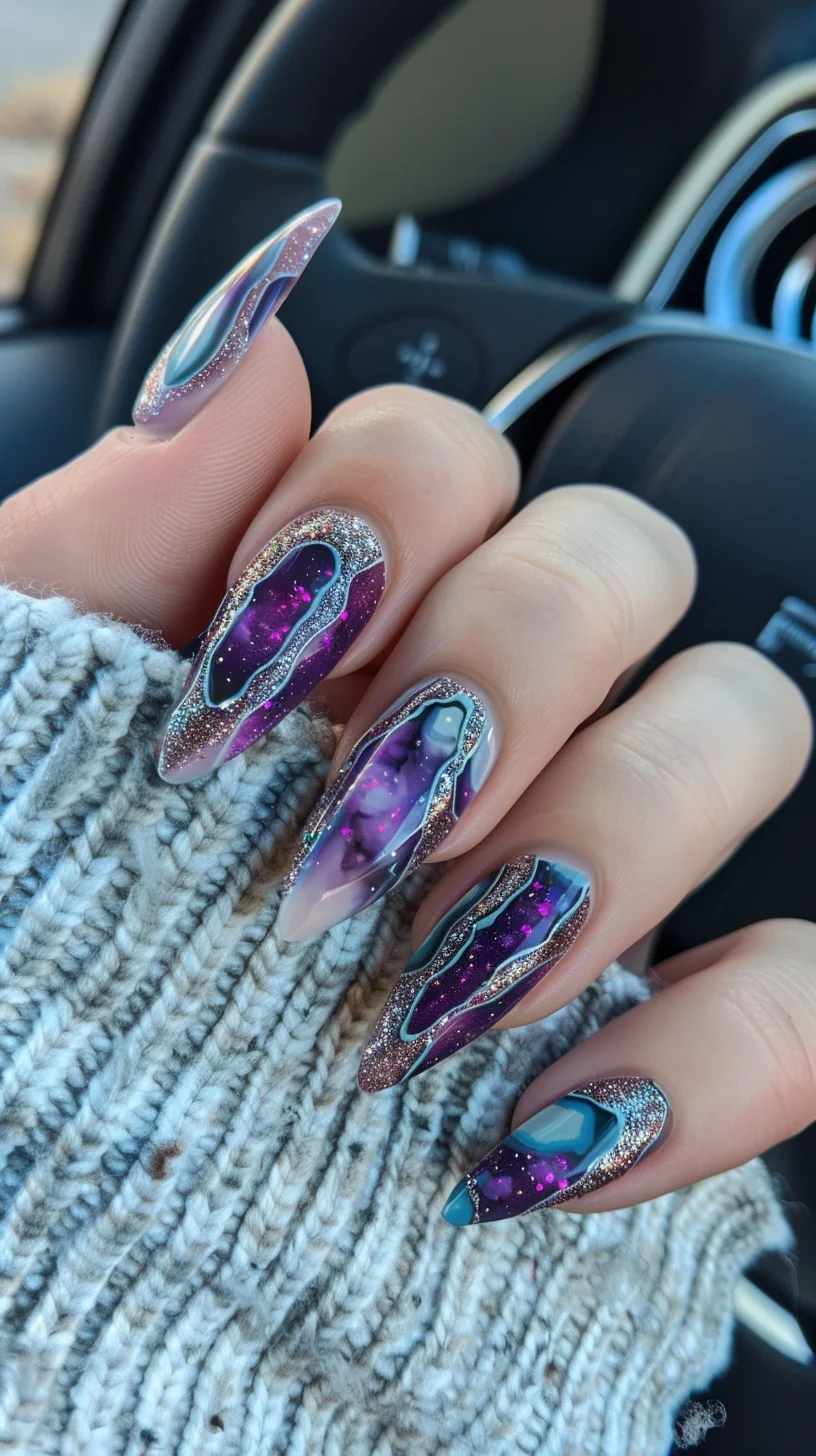 This nail art design masterfully incorporates a mesmerizing combination of deep purples, vibrant teals, and silvery glitter, beautifully crafted to emulate geode formations. Each nail uniquely features a glossy finish with a geode pattern, accentuated by a silver glitter outline that highlights the intricate, organic curves of the design. The central feature of some nails includes a bold, eye-catching teal color block that adds a modern twist to the classic geode look.