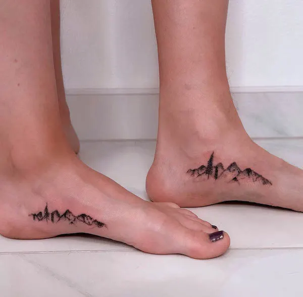 Matching mountain foot tattoos by @kw.skinart