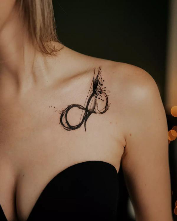 Black splashing infinity collarbone tattoo