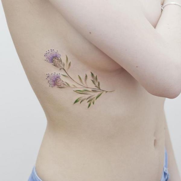 Dainty thistle side boob tattoo