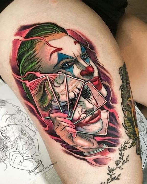 Joker with cards in flame tattoo thigh