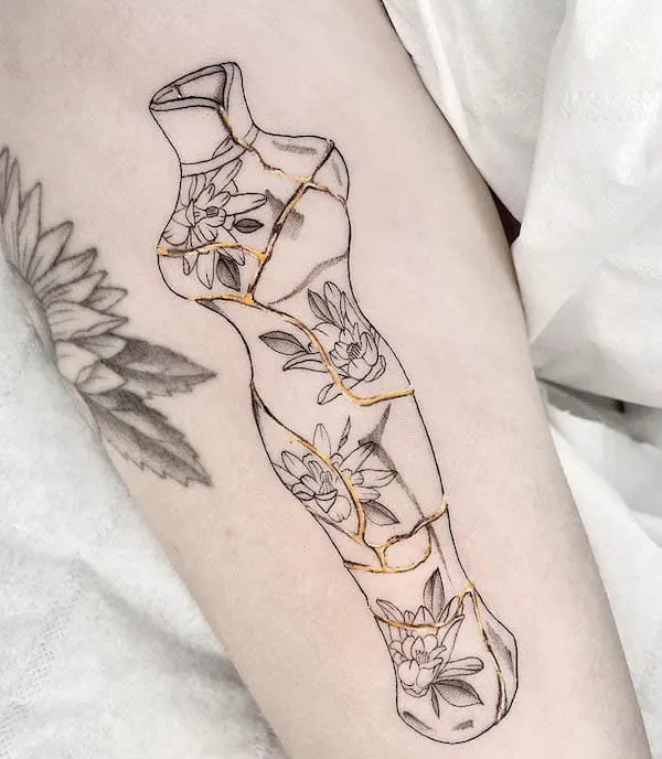 Kintsugi figurine tattoo by @sweetmambatattoo