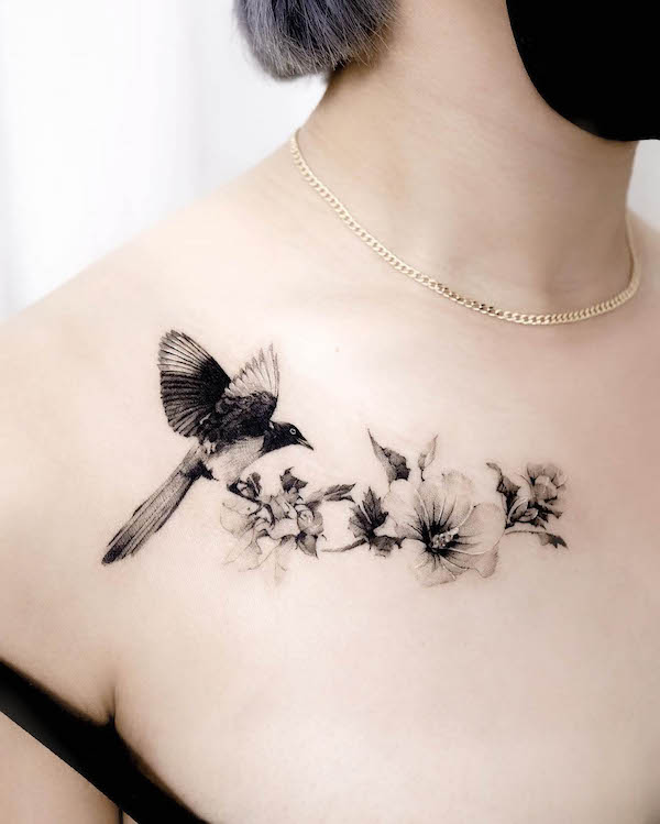 Realism bird and flowers chest tattoo by @nok__ink