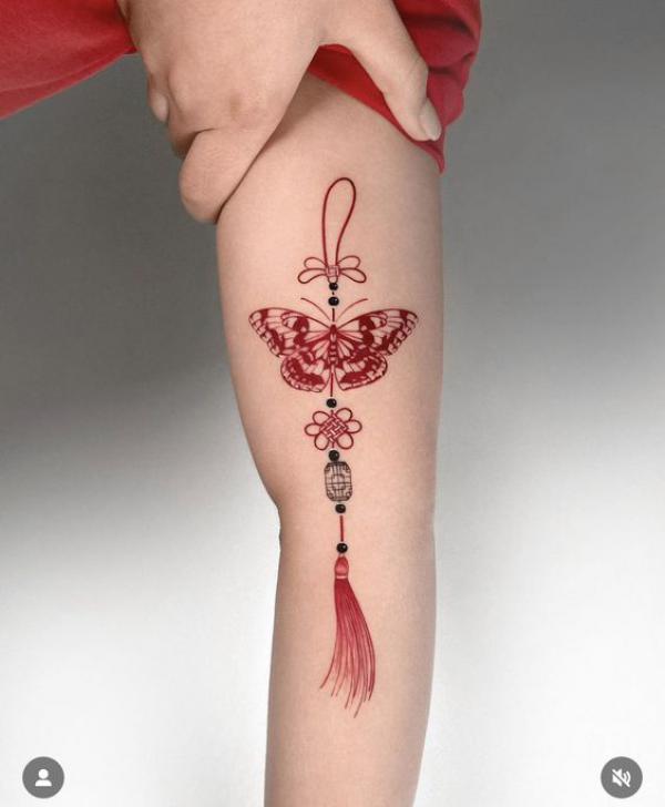 Red butterfly with tassel tattoo